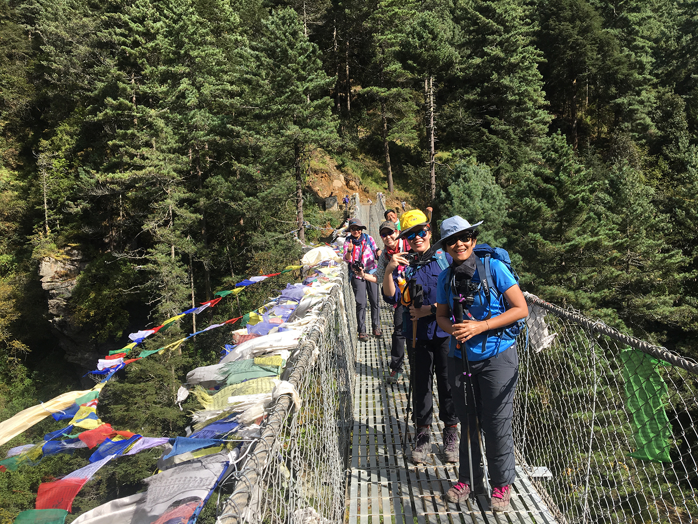 Luxury Everest Base Camp Trekkers pause on the famous Hillary Suspension Bridge enroute to Namche Bazaar.