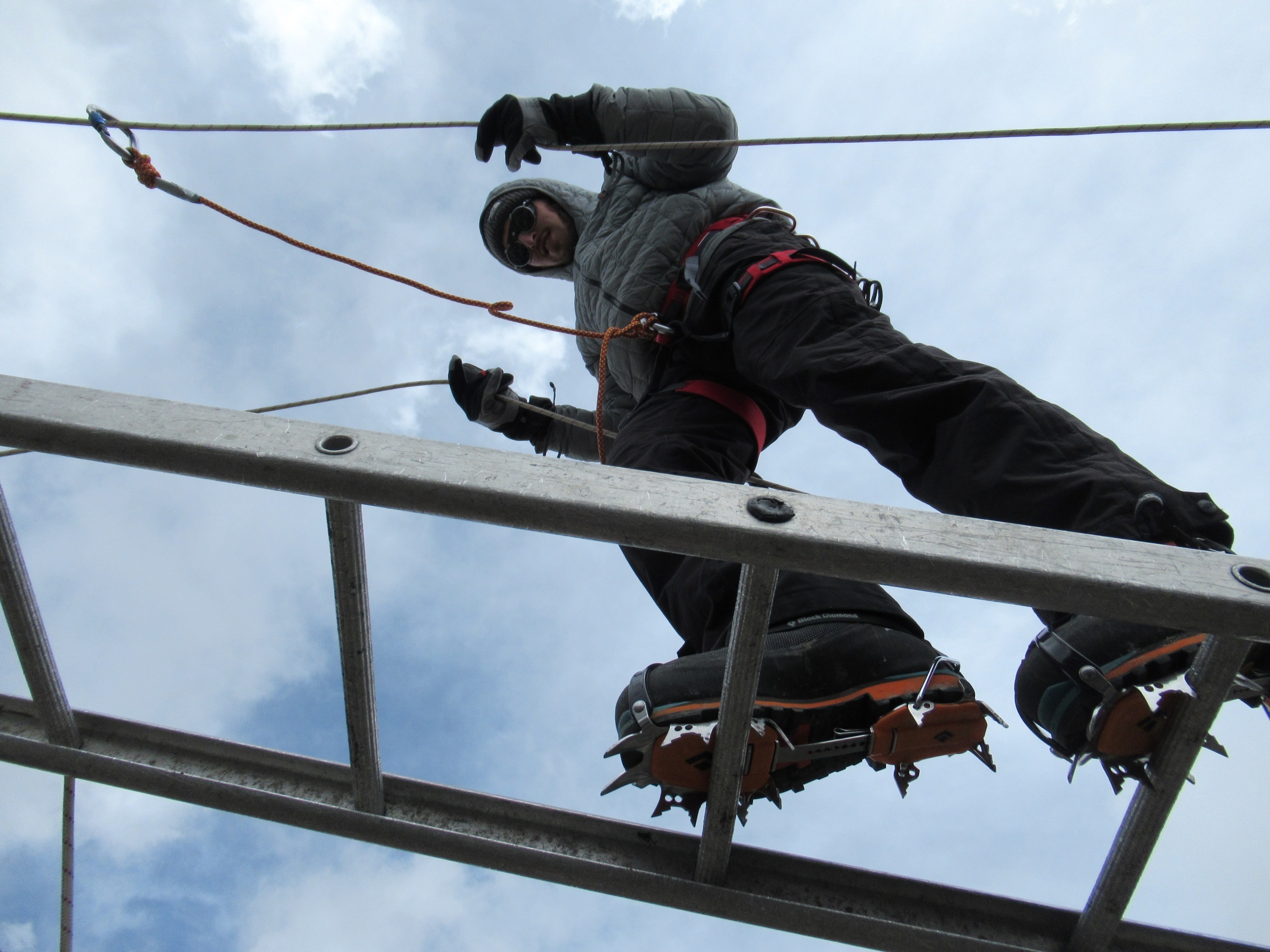 Training in how to cross ladders with crampons on prior to summit day on Island Peak