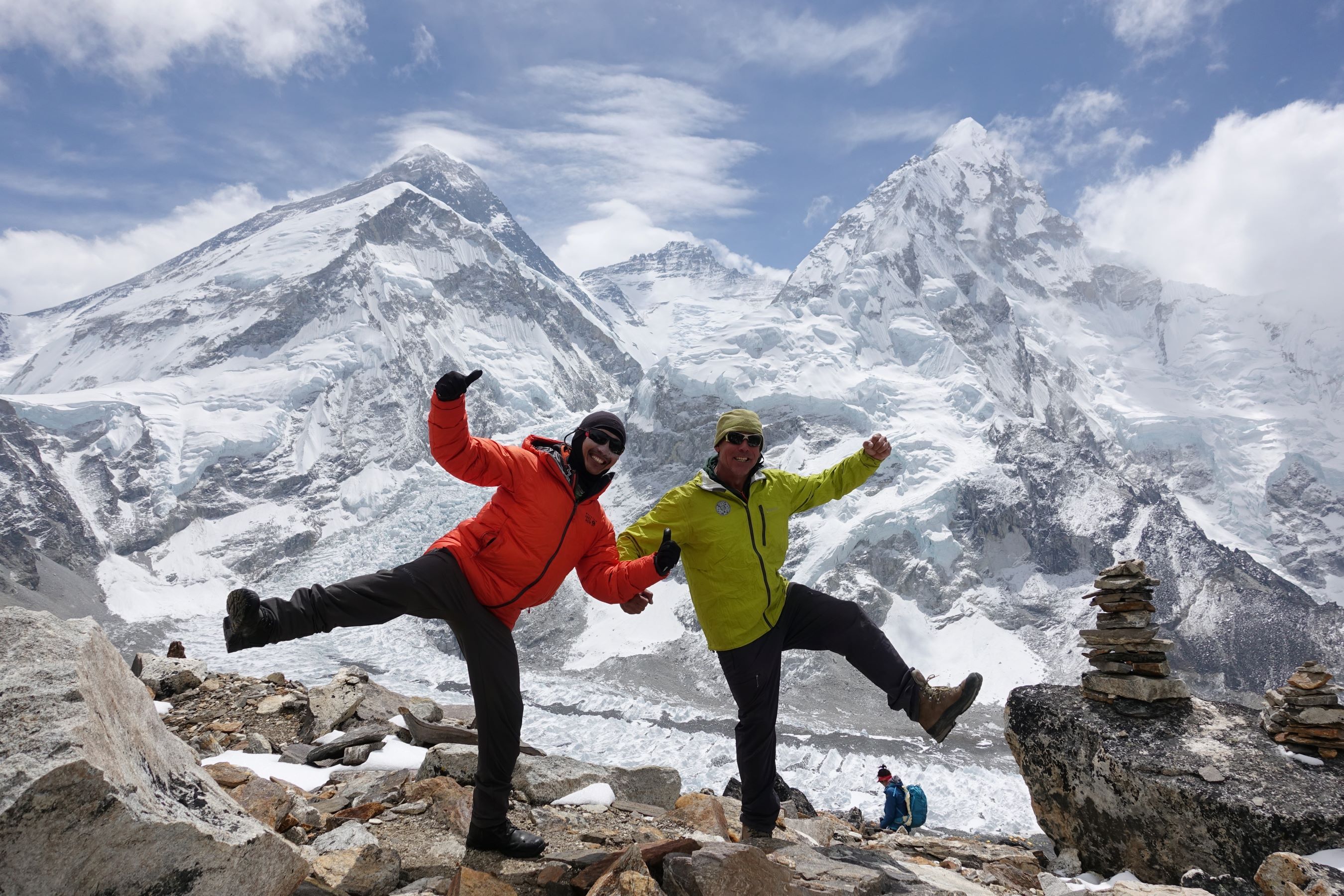 Climbers fooling around with Everest Lhotse and Nuptse behind at the head of the Khumbu glacier