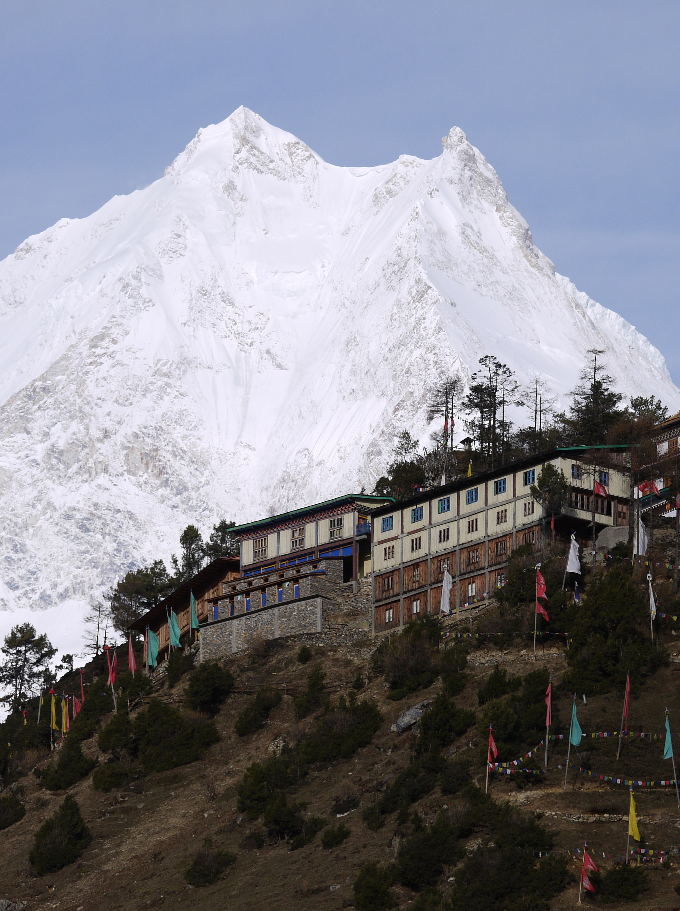 The mighty 8,000m peak Manaslu with the Samagaon Monastery perched on a hill below.